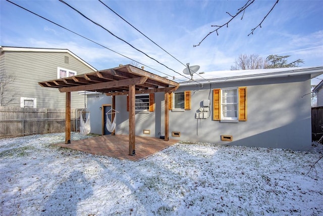 snow covered property featuring a patio area