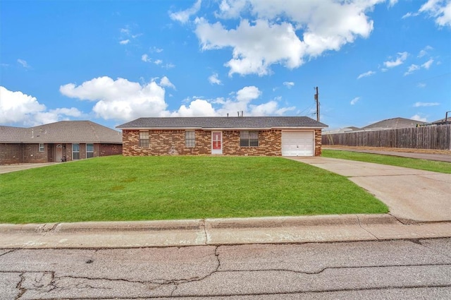 single story home featuring a garage and a front lawn