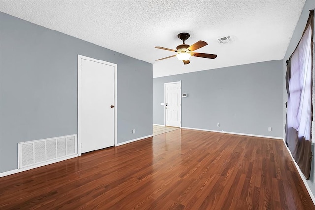 unfurnished room with hardwood / wood-style flooring, ceiling fan, and a textured ceiling