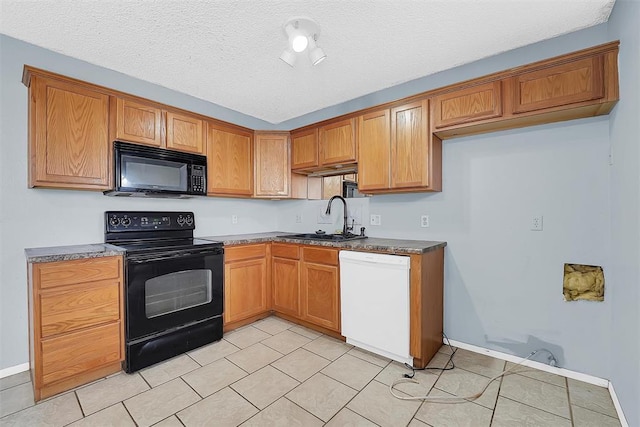 kitchen featuring sink, light tile patterned floors, a textured ceiling, and black appliances