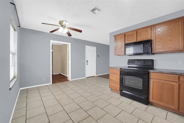 kitchen with light tile patterned flooring, a textured ceiling, ceiling fan, and black appliances