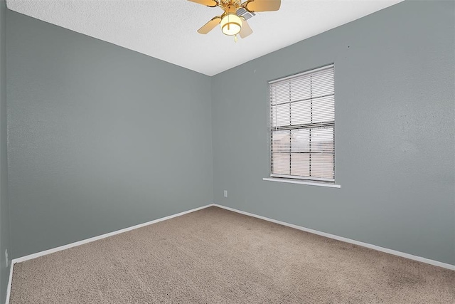 spare room featuring carpet flooring, a textured ceiling, and ceiling fan