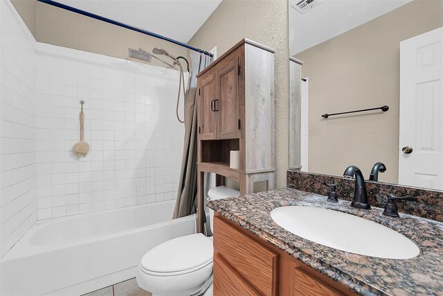 full bathroom featuring vanity, shower / bath combination with curtain, and toilet