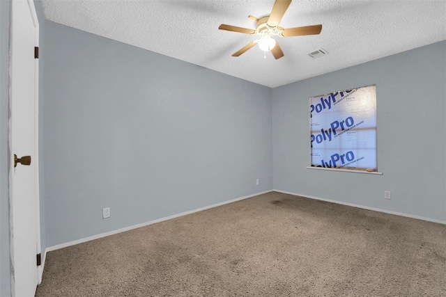 carpeted spare room with ceiling fan and a textured ceiling