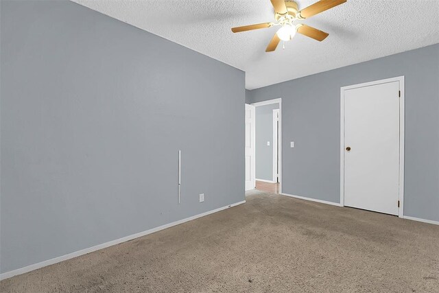 interior space with ceiling fan, carpet flooring, and a textured ceiling