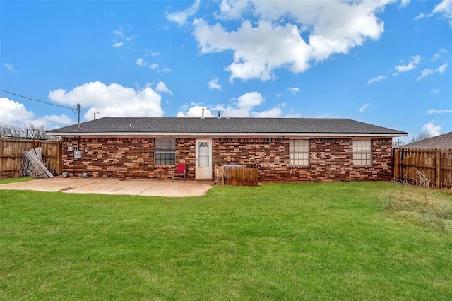 rear view of house featuring a yard and a patio area