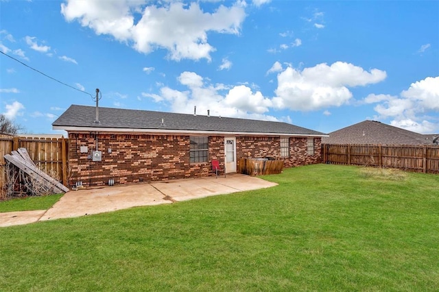 rear view of house with a yard and a patio area