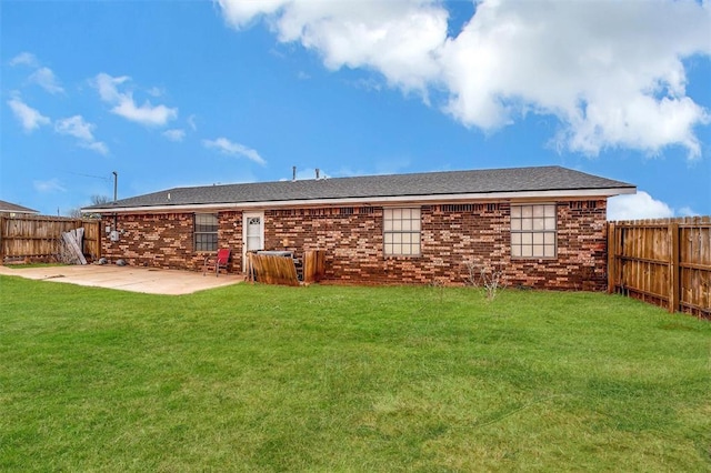 back of property featuring a yard and a patio area