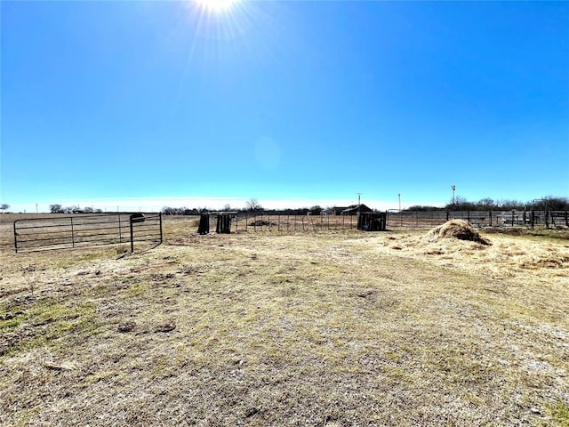 view of yard with a rural view and fence