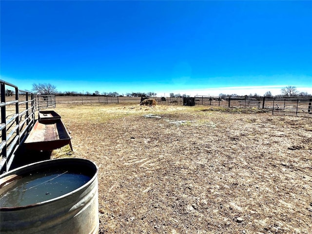 view of yard featuring a rural view and fence