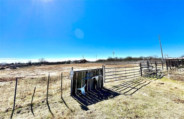 view of yard with a rural view and fence