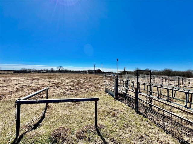 view of yard with a rural view and an outdoor structure