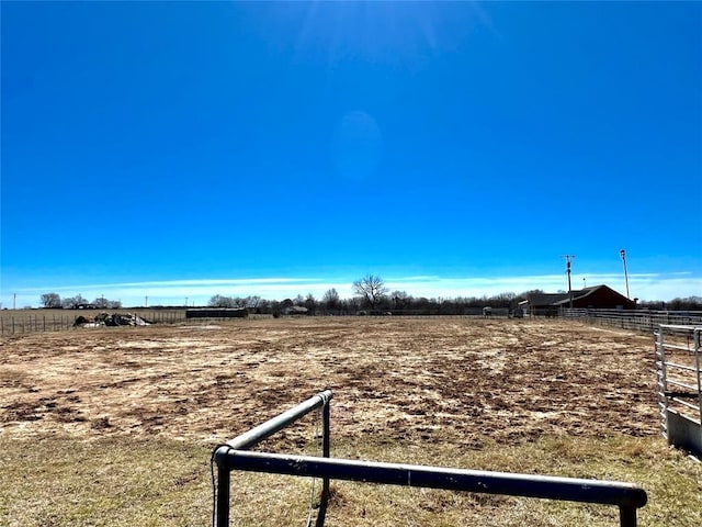 view of yard with a rural view and fence