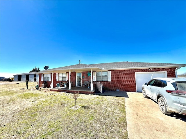 single story home with brick siding, roof with shingles, a porch, a garage, and driveway