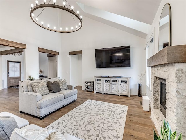 living area featuring high vaulted ceiling, wood finished floors, beam ceiling, and an inviting chandelier