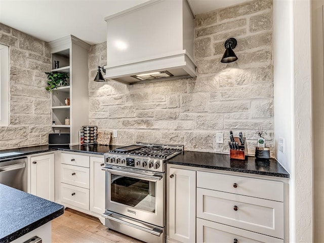 kitchen featuring white cabinets, appliances with stainless steel finishes, light wood-type flooring, custom exhaust hood, and open shelves