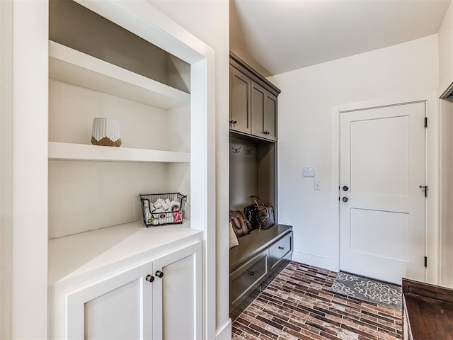 mudroom featuring brick floor