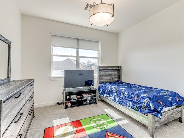 bedroom with baseboards, visible vents, and light colored carpet