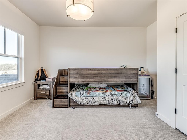 carpeted bedroom featuring baseboards