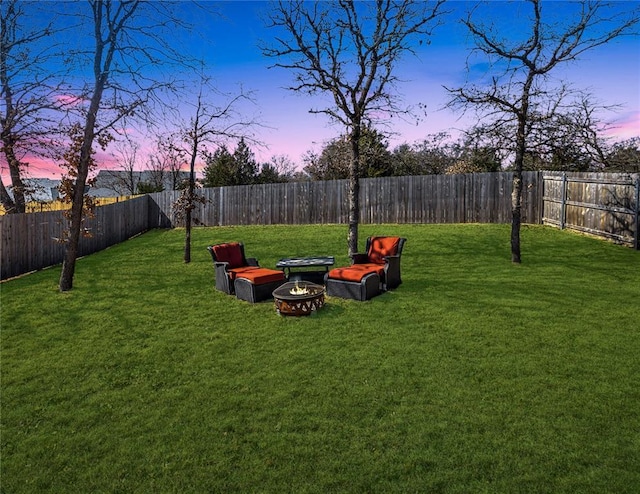 view of yard with a fire pit and a fenced backyard