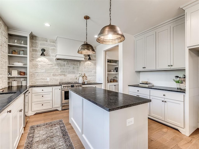 7308 Sunset Sail Ave, Edmond, OK 73034 - kitchen with open shelves, appliances with stainless steel finishes, light wood finished floors, decorative light fixtures, and decorative backsplash