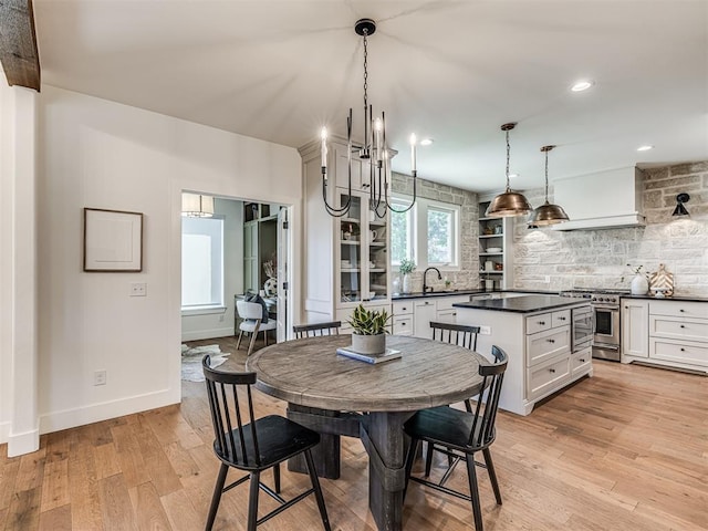 7308 Sunset Sail Ave, Edmond, OK 73034 - dining area with light wood-style floors, recessed lighting, baseboards, and a notable chandelier