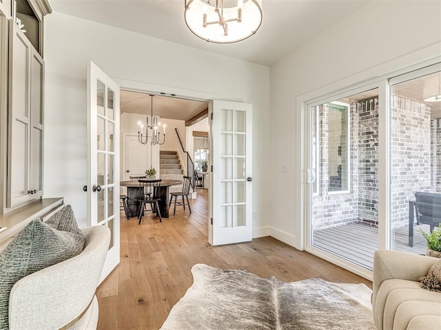 7308 Sunset Sail Ave, Edmond, OK 73034 - doorway with french doors, light wood-style floors, stairs, and a notable chandelier