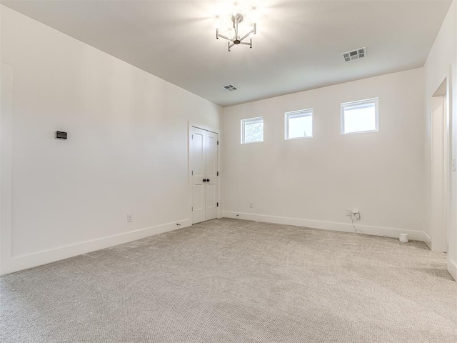 7308 Sunset Sail Ave, Edmond, OK 73034 - spare room with baseboards, visible vents, and light carpet