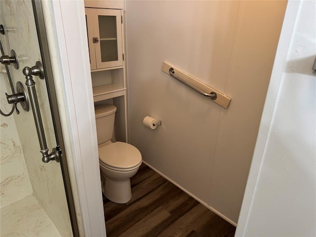 bathroom featuring toilet and wood-type flooring