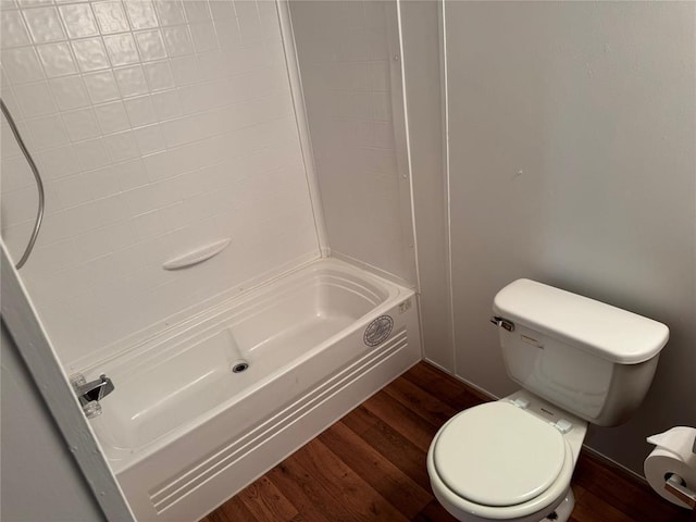 bathroom with hardwood / wood-style flooring, toilet, and shower / bath combination