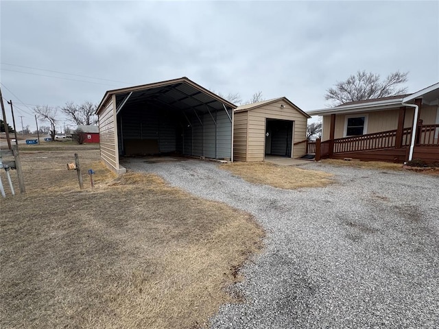 view of outbuilding with a garage and a carport