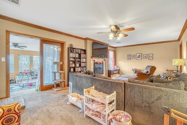 living room with crown molding, ceiling fan, and carpet floors