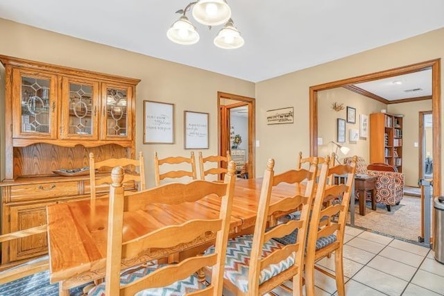 dining room featuring light tile patterned flooring and ornamental molding