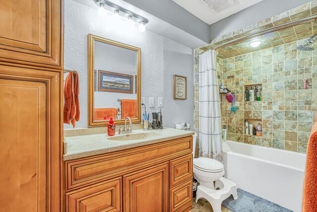 full bathroom featuring vanity, shower / tub combo, and toilet