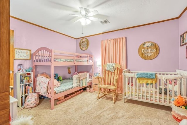 bedroom featuring crown molding, carpet floors, and ceiling fan