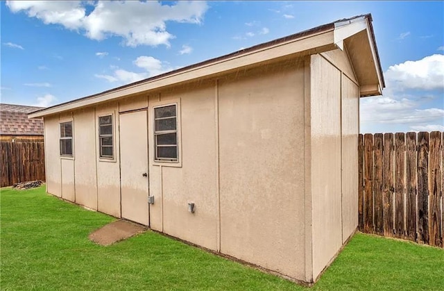 view of outbuilding with a lawn