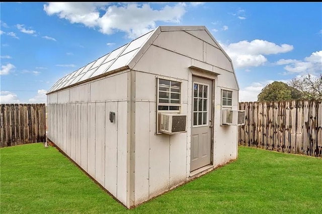 view of outbuilding with cooling unit and a yard