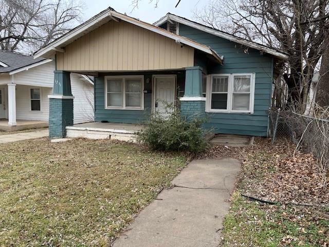 bungalow-style house with a front yard and a porch