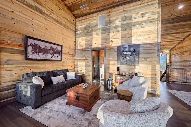 living room with high vaulted ceiling, wood walls, wooden ceiling, and wood finished floors