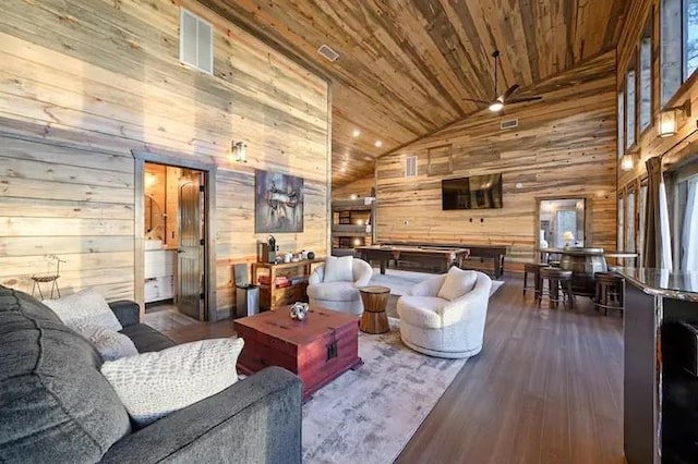 living room with dark wood-type flooring, wood walls, ceiling fan, high vaulted ceiling, and wooden ceiling