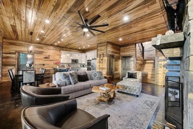 living room with wooden walls, recessed lighting, a ceiling fan, wood ceiling, and dark wood finished floors