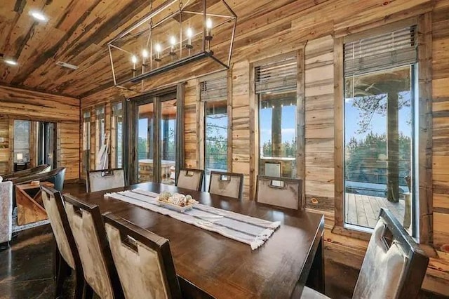 unfurnished dining area featuring a wealth of natural light, wood walls, wood ceiling, and a notable chandelier