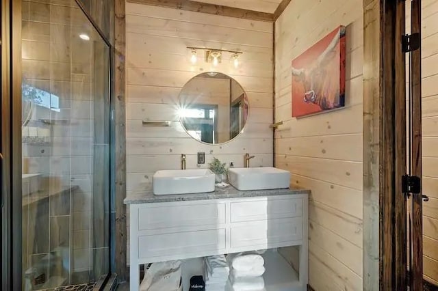 bathroom with double vanity, wooden walls, and a sink