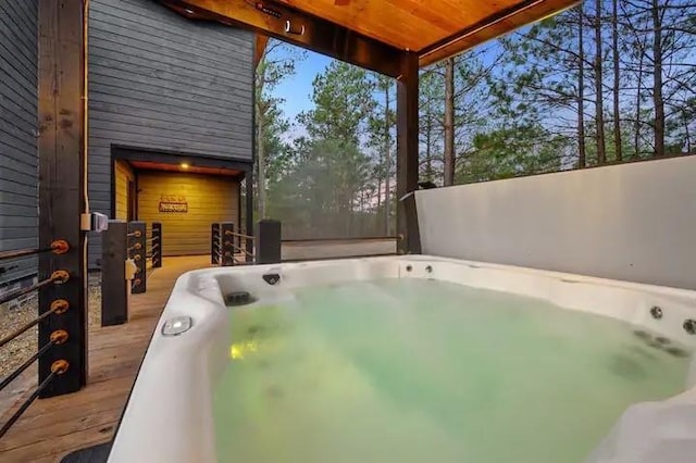 view of patio featuring a hot tub and a deck