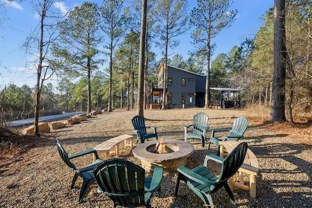 view of yard with an outdoor fire pit