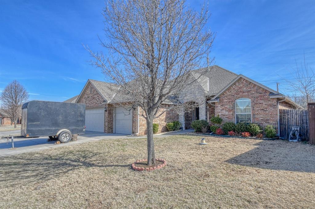 view of front of home with a front yard and a garage