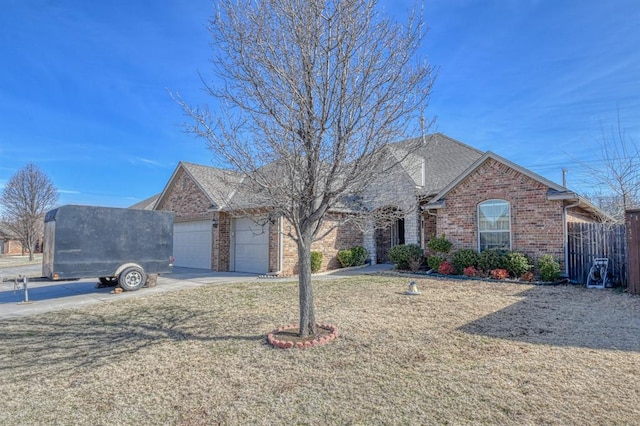 view of front of home with a front yard and a garage