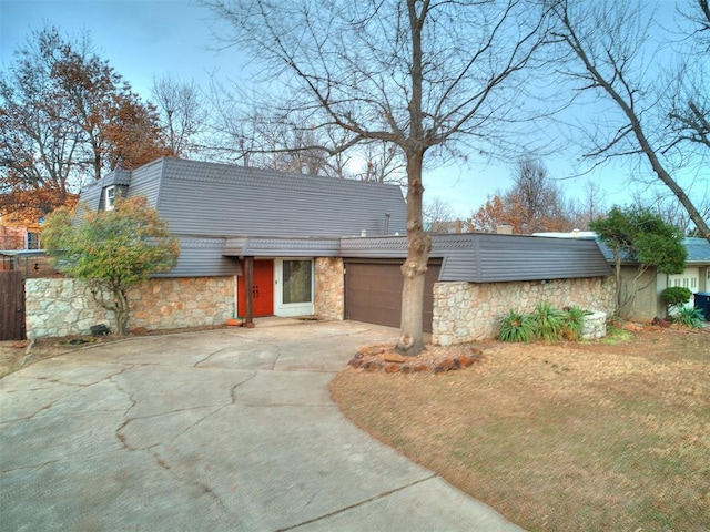 view of front of property featuring a garage and a front lawn