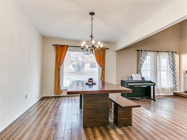 dining room with a notable chandelier and dark hardwood / wood-style floors