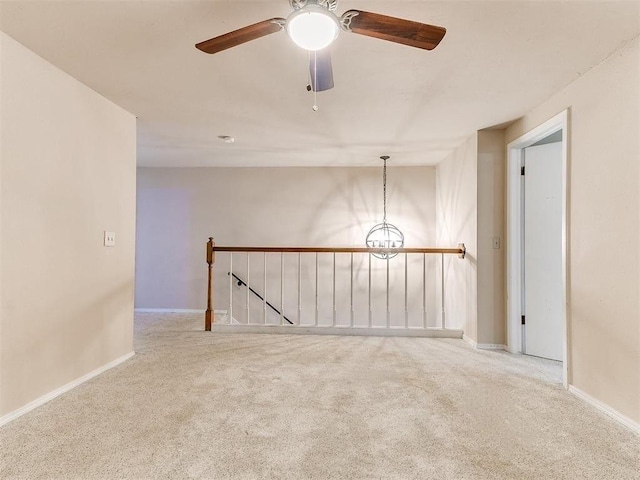 spare room with ceiling fan and light carpet